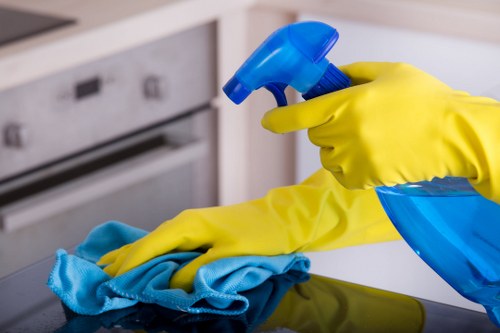 Local cleaner tidying a kitchen and bathroom in Streatham
